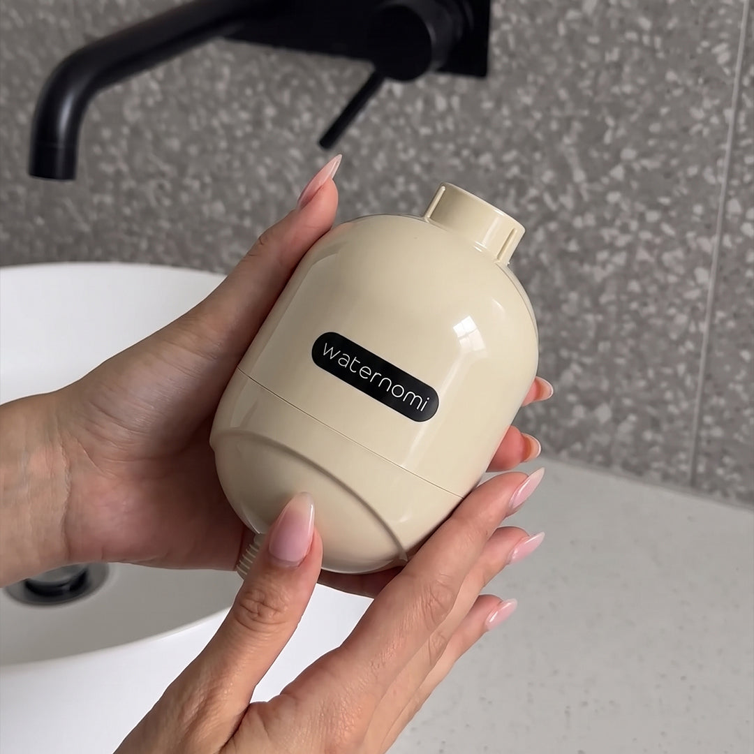 Waternomi shower filter held in a modern bathroom